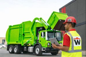 Property maintenance team loading a bulk item onto a WasteIt truck in Kansas City